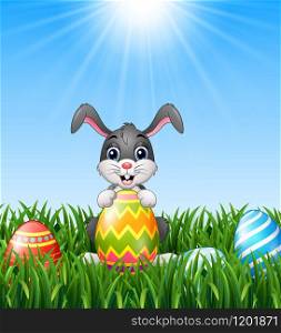 Cartoon bunny holding easter eggs in the grass