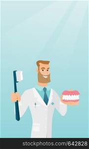 Caucasian dentist showing a dental jaw model and a toothbrush. Young dentist holding a dental jaw model and a toothbrush in hands. Dentistry concept. Vector flat design illustration. Vertical layout.. Dentist with a dental jaw model and a toothbrush.