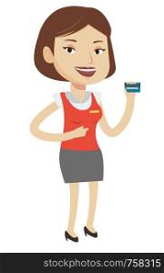 Caucasian female cashier holding credit card. Happy female cashier at work. Smiling cashier pointing with her finger at credit card. Vector flat design illustration isolated on white background.. Cashier holding credit card at the checkout.