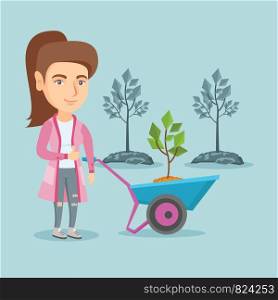 Caucasian gardener standing with wheelbarrow on the background of newly planted trees. Young gardener pushing wheelbarrow with tree and giving thumb up. Vector cartoon illustration. Square layout.. Caucasian woman pushing wheelbarrow with plant.