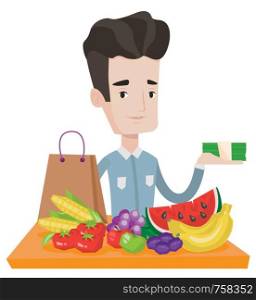 Caucasian shopper standing at the table with grocery purchases. Shopper holding money in hand in front of table with grocery purchases. Vector flat design illustration isolated on white background.. Young man standing at the table with shopping bag