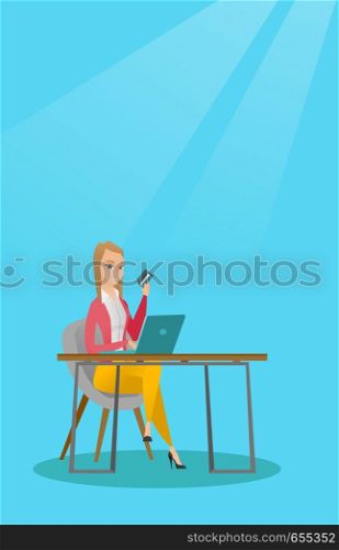 Caucasian woman sitting at the table with laptop and holding a credit card in hand. Woman using laptop for online shopping and paying by credit card. Vector flat design illustration. Vertical layout.. Young caucasian woman paying online by credit card
