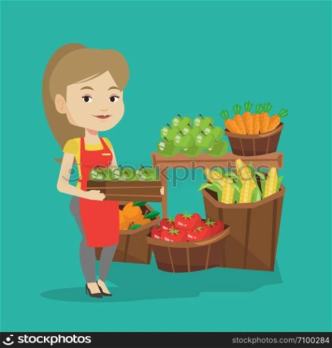 Caucasian worker of grocery store standing in front of section with vegetables and fruits. Female worker of grocery store holding a box with apples. Vector flat design illustration. Square layout.. Supermarket worker with box full of apples.