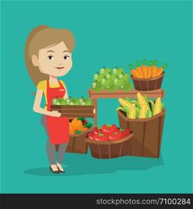 Caucasian worker of grocery store standing in front of section with vegetables and fruits. Female worker of grocery store holding a box with apples. Vector flat design illustration. Square layout.. Supermarket worker with box full of apples.