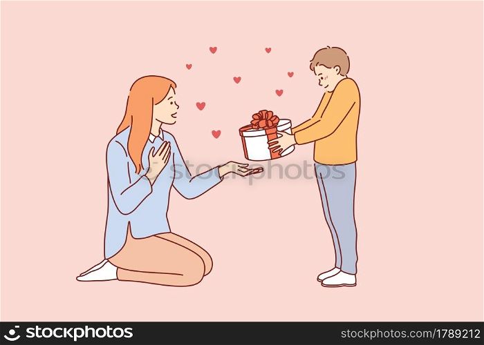 Celebrating Happy Mothers day concept. Small smiling boy cartoon character standing giving present box to his young mother for holiday vector illustration . Celebrating Happy Mothers day concept.