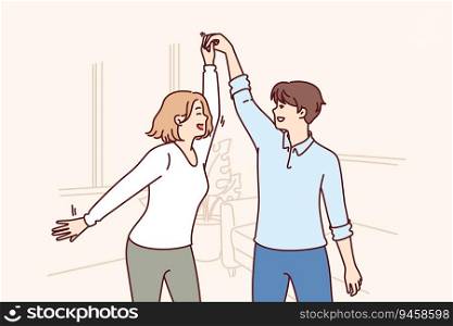 Cheerful couple dancing in apartment rejoicing moving and relocation to new house taken on mortgage in bank. Happy man and woman dancing waltz celebrating buying real estate in luxury area. Cheerful couple dancing in apartment rejoicing moving and relocation to new house taken on mortgage