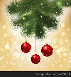 Christmas background with baubles hanging from a fir tree branch on a bokeh lights background