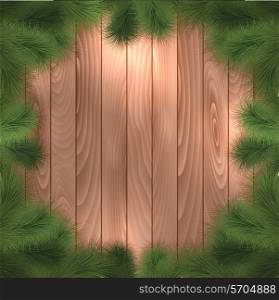 Christmas tree branches on a wooden background