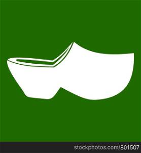 Clogs icon white isolated on green background. Vector illustration. Clogs icon green