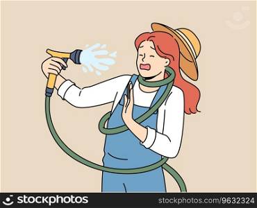 Clumsy woman with garden hose accidentally sprays herself with water while watering backyard lawn during drought. Girl got tangled in garden hose due to failure or lack knowledge of safety precautions. Clumsy woman with garden hose accidentally sprays herself with water while watering backyard lawn