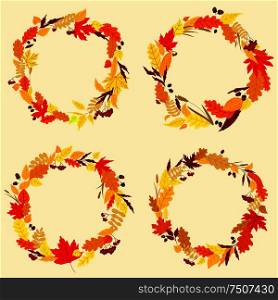 Colorful garlands or wreaths of autumn and fall leaves in shades of orange, red and yellow with central copyspace. Colorful wreaths of autumn leaves