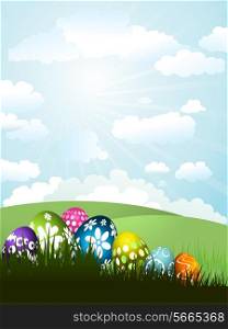Colourful Easter eggs in grass on a sunny landscape background