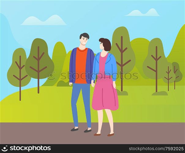 Couple in casual cloth spend time together outdoors. People in love and fall season, man and woman walking in autumn park among yellow and orange trees. Couple in Casual Cloth Spend Time Together Outdoor