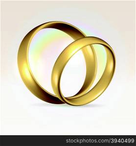 Couple of golden polished wedding rings over light background