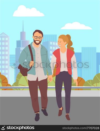 Couple walking down the street. Young bearded guy in glasses and girl holding hands walking in summer day in city park, romantic walk. Pleasant promenade in the open air on a date, active lifestyle. Couple walking down the street. Young guy and girl holding hands walking in summer day in park
