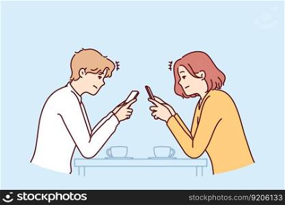 Couple with phones sits in cafe, addiction to social networks and internet chatting, not paying attention to interlocutor. Concept of social problems associated with digital addiction to gadgets. Couple with phones sits in cafe, addiction to social networks, not paying attention to interlocutor