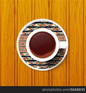 Cup of coffee on a saucer with Tribal pattern. Vector illustration