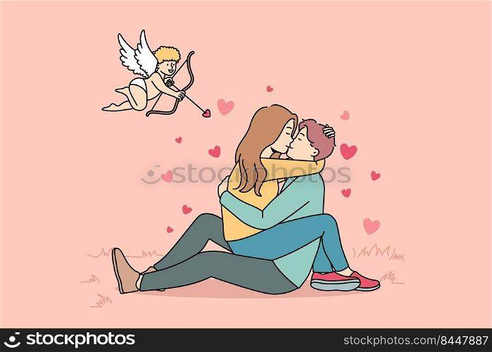 Cupid shooting with arrows in to happy couple kissing. Woman sitting on man hugging and cuddling. Love and relationship. Vector illustration.. Cupid shooting at couple in love