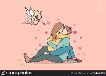 Cupid shooting with arrows in to happy couple kissing. Woman sitting on man hugging and cuddling. Love and relationship. Vector illustration.. Cupid shooting at couple in love