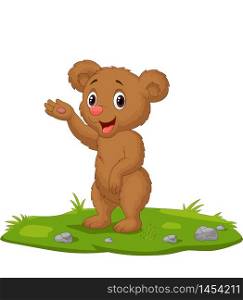 Cute baby bear waving hand on the grass