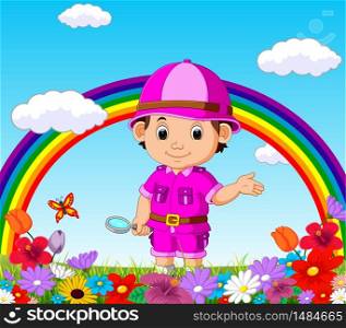 Cute boy holding magnifying glass in a flower garden with rainbow