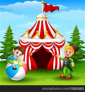 Cute boy on colorful ball and elf waving hand on the circus tent background