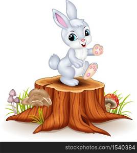 Cute bunny standing on tree stump