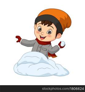 Cute little boy in winter clothes throwing snowball