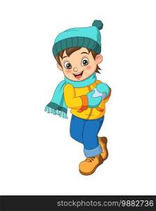 Cute little boy in winter clothes with snowball