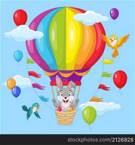 Cute little bunny and easter eggs flying in hot air balloon