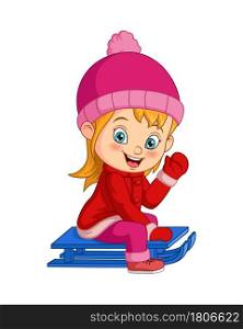 Cute little girl sledding down a hill