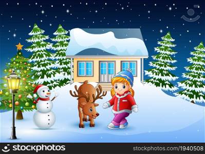 Cute little girl with a deer in front of snowy house in christmas day