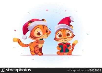 Cute New Year tiger cartoon character in Santa Claus hat with gift box in paws and confetti falling. Wild funny kitten animal cub with present, kawaii 2022 chinese zodiac symbol, Vector illustration. Cute New Year cartoon tiger in Santa Claus hat