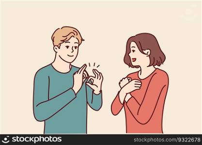 Deaf-mute man and woman are talking using sign language and demonstrating symbols with hands. Guy teaches girl sign language for concept of inclusiveness and socialization of people with disabilities. Deaf-mute man and woman are talking using sign language and demonstrating symbols with hands
