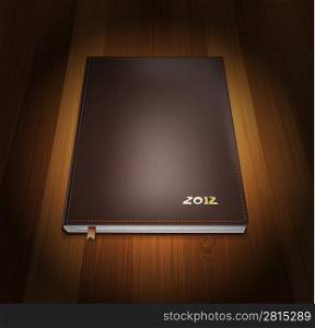 Diary in cover leather on wooden background