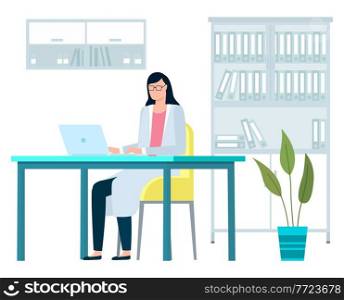Doctor with computer is doing medical presentation. The girl works in a hospital room. Woman in glasses and a medical gown sits in the office at a laptop. Therapist works remotely with technology. Female doctor with laptop computer doing medical presentation. The girl works in a hospital room