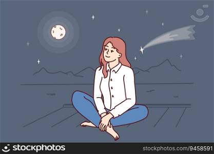 Dreamy woman is sitting on pier looking at night sky with shooting star near full moon. Carefree dreamy girl admires evening bay and makes wishes seeing starfall and feels harmony with nature. Dreamy woman is sitting on pier looking at night sky with shooting star near full moon
