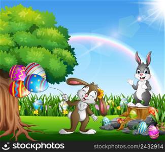 Easter bunnies and colorful egg on the garden