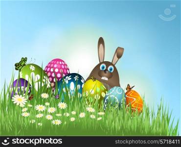 Easter bunny and eggs nestled in grass and flowers
