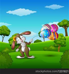 Easter bunny holding easter eggs balloons in the park
