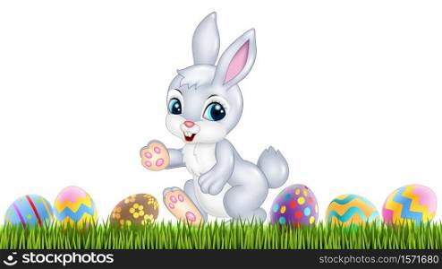 Easter bunny with decorated Easter eggs in a field