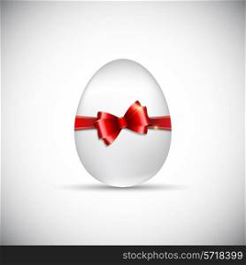 Easter egg with a glossy red ribbon