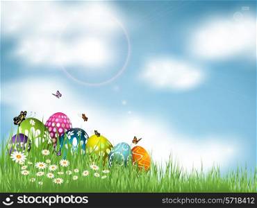 Easter eggs nestled in grass against a blue sky with butterflies