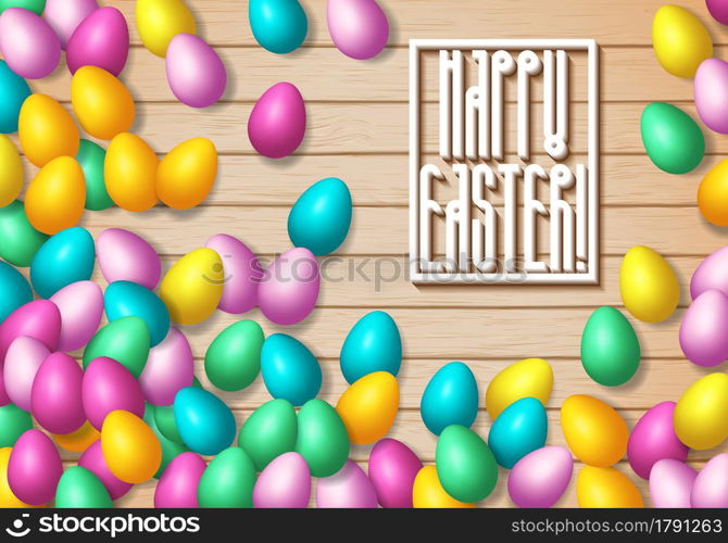 Easter frame with shiny colorful eggs spread over wooden background