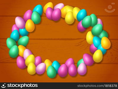 Easter frame with shiny colorful eggs spread over wooden background