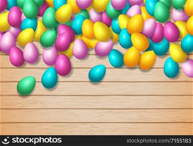 Easter frame with shiny colorful eggs spread over wooden background
