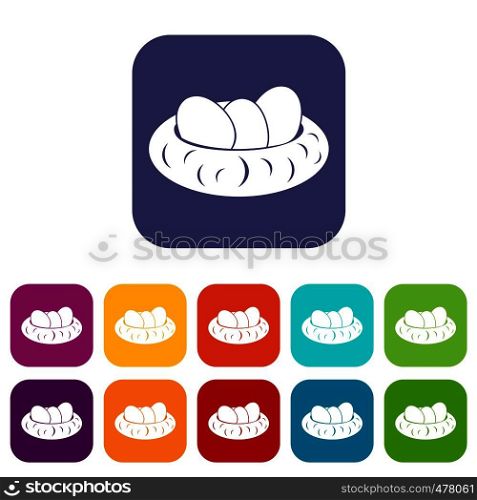 Eggs in the nest icons set vector illustration in flat style in colors red, blue, green, and other. Eggs in the nest icons set