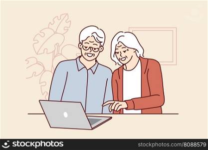 Elderly men and women are sitting at table with laptop learning how to handle modern technology and computer literacy. Elderly couple make video call to children using laptop with internet. Elderly men and women are sitting at table with laptop learning how to handle modern technology