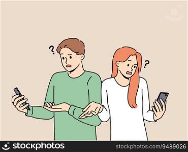 Embarrassed people with phone see error connecting to internet wifi or dead battery of gadget shrug. Man and woman are having problems due to broken mobile phone or reading fake news.. Embarrassed people with phone see error connecting to internet wifi or dead battery of gadget shrug