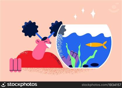 Enjoying home pets life concept. Smiling happy girl cartoon character standing looking at home golden fish in aquarium vector illustration . Enjoying home pets life concept